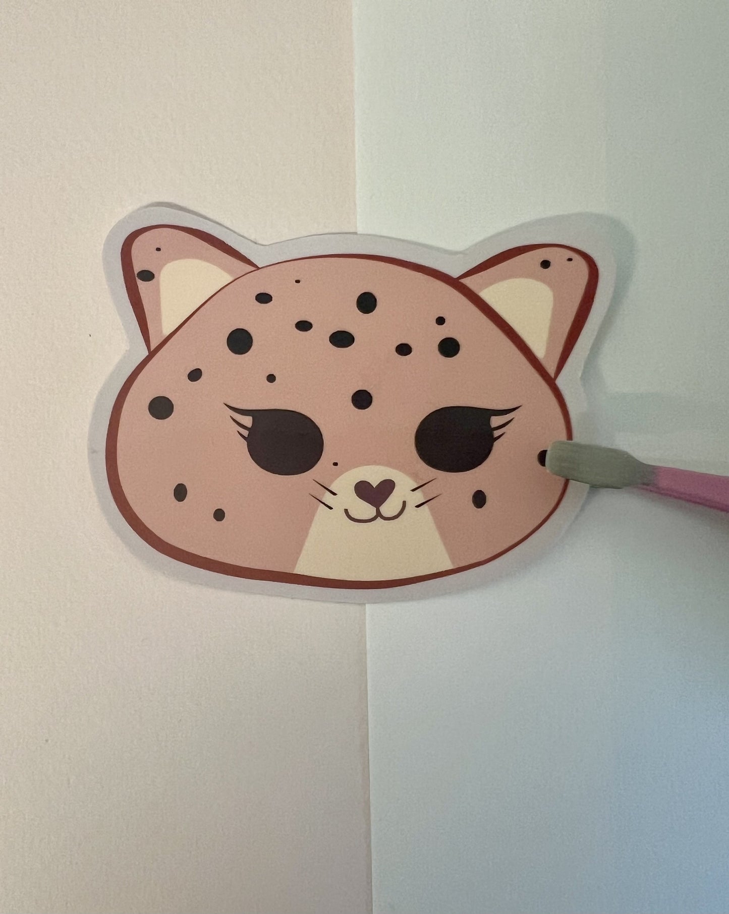 Kawaii jaguar face die-cut sticker on a white background