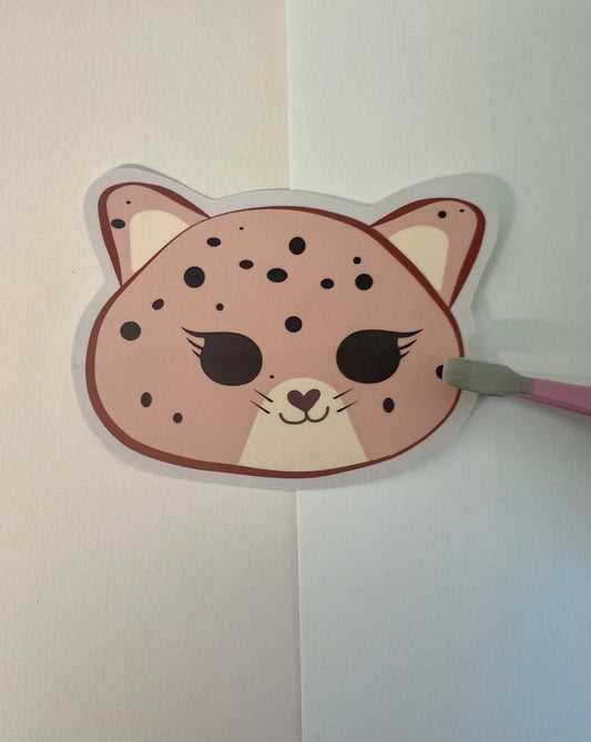 Kawaii jaguar face die-cut sticker on a white background