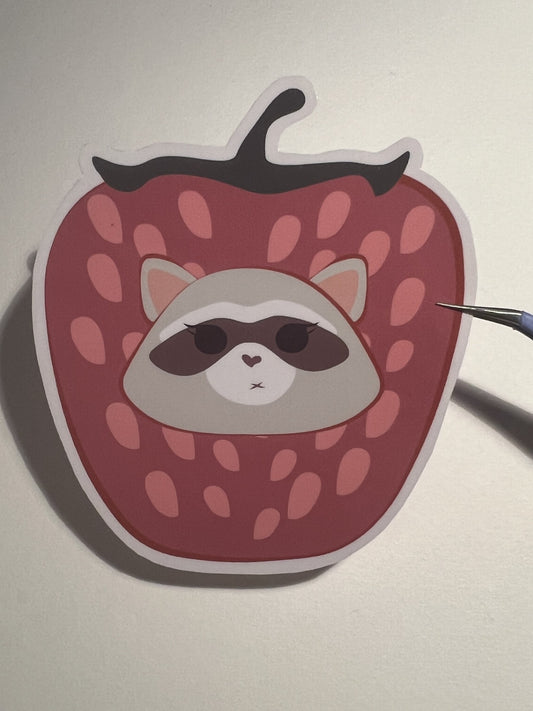 Strawberry with a raccoon sticker 